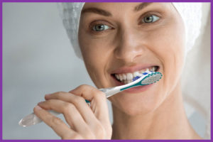 Woman brushing teeth with BrightWorks Premium Toothbrush