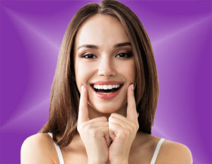 Smiling woman pointing showing off white teeth