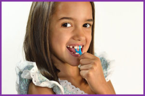 Young girl smiling and flossing
